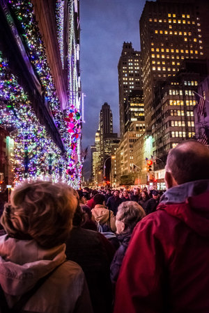 NEW YORK-DECEMBER 7: A crowded sidewalk surrounded by holiday lights along 5th Avenue on December 7 2016 in New York City.のeditorial素材