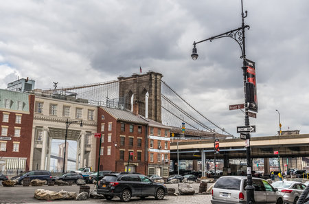 NEW YORK-MARCH 23: A street view with the Brooklyn Bridge and apartment buildings on March 23 2018...