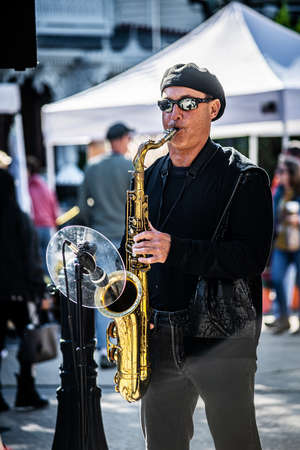 OCEAN GROVE, NEW JERSEY -OCTOBER 5: The saxophone player in the band outdoors during a craft festival on October 5 2019 in Ocean Grove New Jersey.のeditorial素材