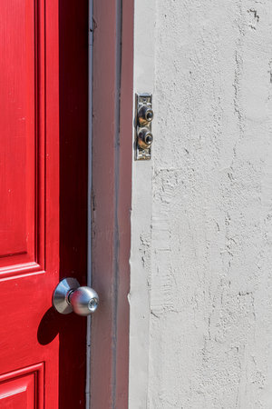 A double doorbell and rec door with stucco exterior wall.