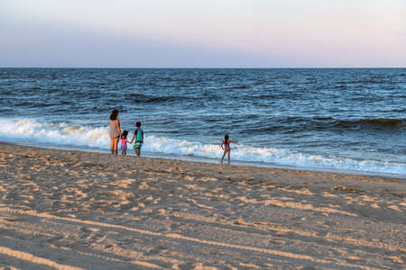 LONG BRANCH, NEW JERSEY - AUGUST 14: A family enjoys their time on the beach during twilight on  August 14  2020 in Long Branch New Jersey.のeditorial素材