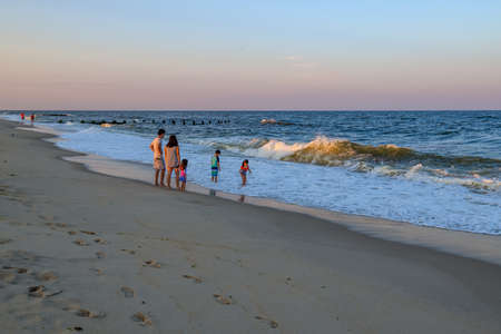 LONG BRANCH, NEW JERSEY - AUGUST 14: A family enjoys their time on the beach during twilight on  August 14  2020 in Long Branch New Jersey.のeditorial素材