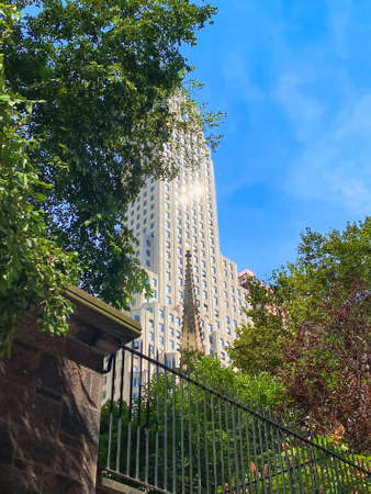 Looking up at a lower Manhattan skyscraper on a bright Summer day.の写真素材