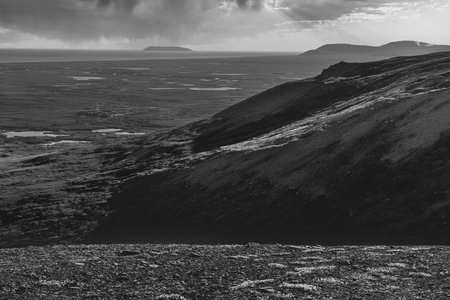 A black and white landscape with Sledge Island off Nome Alaska in the distance.の写真素材