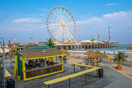 ATLANTIC CITY, NEW JERSEY - JULY 18: The amusement pier and a beach bar on July 18, 2023 in Atlantic City, New Jersey.のeditorial素材