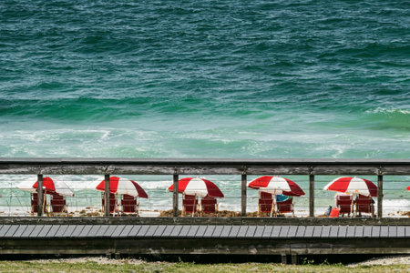 Colorful beach umbrellas framed through the boarwalk on Miramar beach in Destin, Florida.の写真素材