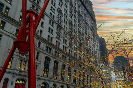 A red steel sculpture in lower Manhattan during the holiday season.の写真素材