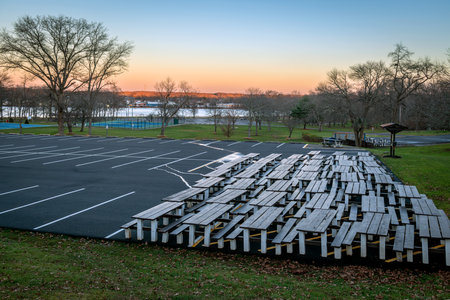 Picnic tables put to the side of this parking lot in Thompson Park in Monroe, New Jersey.の写真素材
