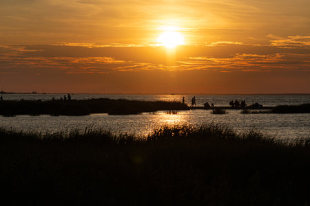 The sun sets over Sandy Hook Bay along the Jersey shore.の写真素材
