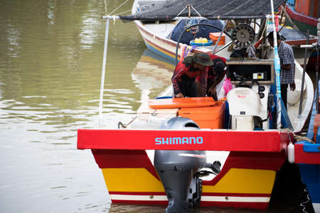 Kedah,Malaysia - 11-05-2019 : fisherman selling fish at the pier when after harvested from the sea.のeditorial素材