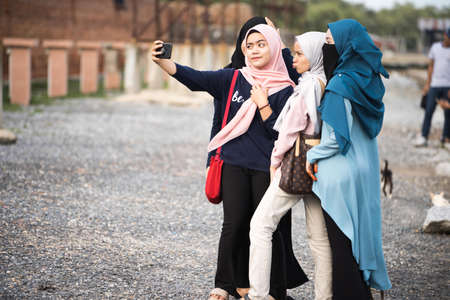 Kedah,Malaysia - asian hijab's girl taking photo in the tourist spot when holiday in Kedah,Malaysia.のeditorial素材