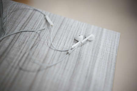 White earphone on the wooden tableの写真素材