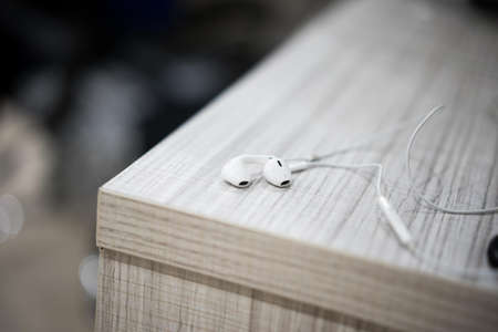 White earphone on the wooden tableの写真素材
