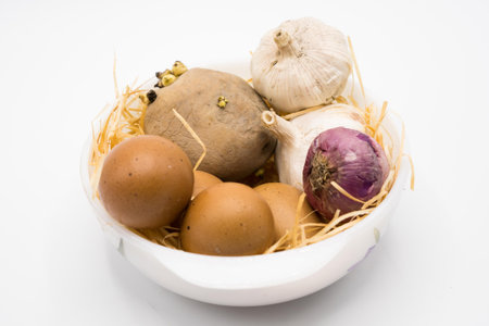 mix of egg potato onion and garlic on the nest with white background.