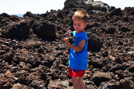 Child holding a piece of set lavaの写真素材