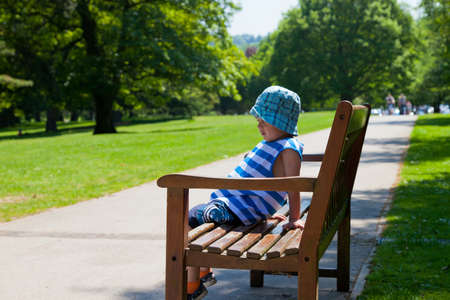 Child on bench in parkの写真素材