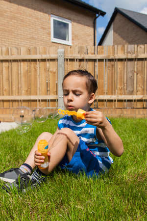 Child making bubbles outdoorの写真素材