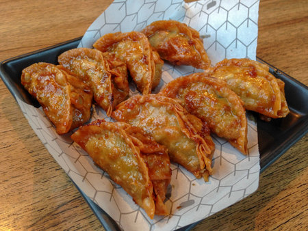 Close up to gyoza, Japanese word in original is Chinese dumpling (dim sum, jiaozi), but rich garlic...