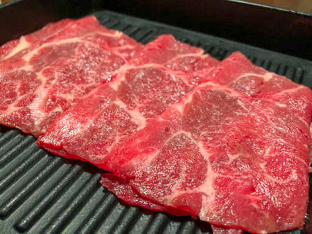 Close to fresh sliced beef, thinly sliced to boiled (Shabu, sukiyaki) in hot pot or grilled on charcoal flame (barbecue)の写真素材