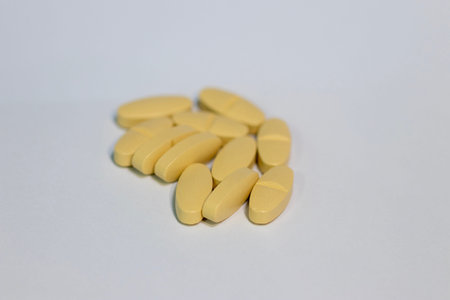 Closeup yellow supplement tablet 1000 mg isolated with white background