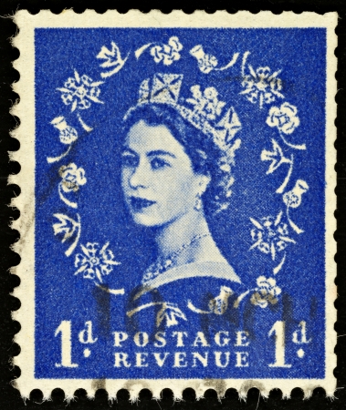 UNITED KINGDOM - 1952 - 1965: An English One Pence Blue Used Postage Stamp showing Portrait of Queen Elizabeth 2nd, 1952 - 1965 のeditorial素材