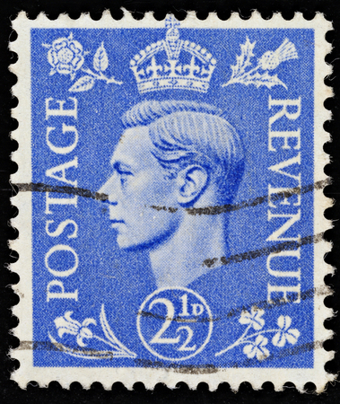 UNITED KINGDOM - 1937 - 1947: An English Two and a Half Pence Blue Postage Stamp showing Portrait of King George VI, 1937 - 1947 のeditorial素材