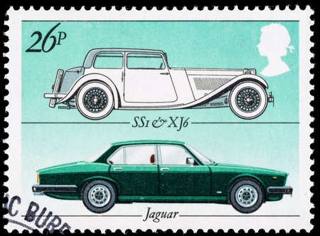 UNITED KINGDOM - CIRCA 1982: A British Used Postage Stamp celebrating the British Motor Industry, showing Jaguar SSI and Jaguar XJ6 Carsのeditorial素材