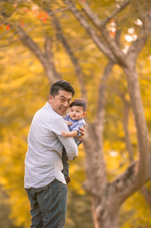 Asian father and son having fun outdoors の写真素材