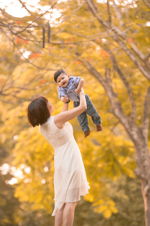 Asian mother and son having fun outdoors の写真素材