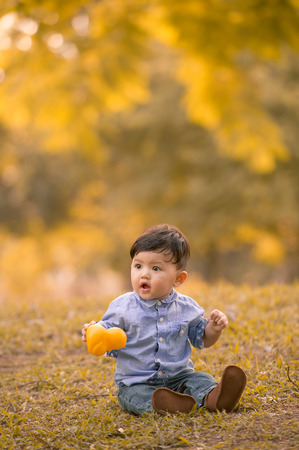 Asian 10-month old boy having fun outdoorsの写真素材