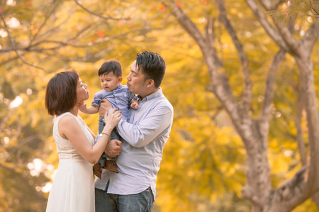 Asian young family having fun outdoors in autumnの写真素材