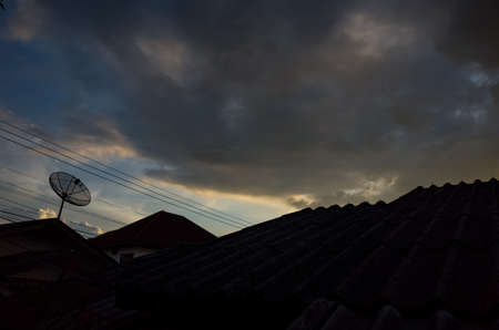 satellite antenna on the roof with cloudy backgroundの写真素材