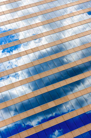 Cloud and sky reflection in the windows of modern officeの写真素材