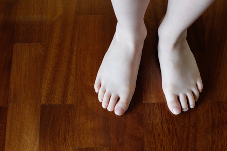 Baby feet on the parquetの写真素材