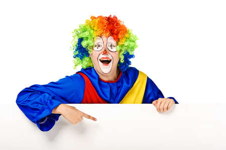 Funny clown standing over a white background and pointingの写真素材