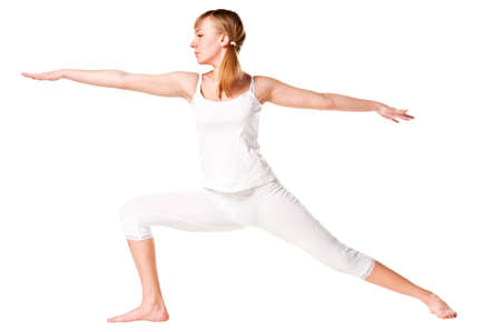 Young woman doing yoga exercise. Isolated over whiteの写真素材