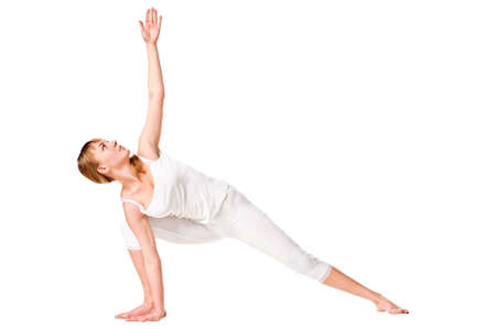 Beautiful young woman doing yoga exercise, isolated over whiteの写真素材