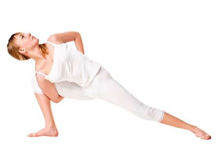Young woman doing yoga exercise. Isolated over whiteの写真素材
