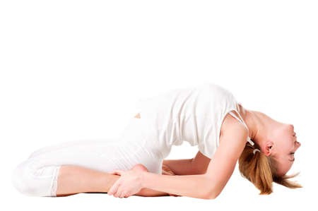 Young woman doing yoga exercise. Isolated over whiteの写真素材