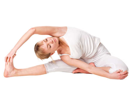 Young woman doing yoga exercise. Isolated over whiteの写真素材