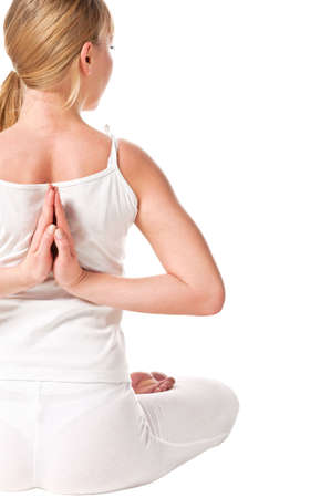 Young woman in the lotus pose. Rear view. Isolated over whiteの写真素材