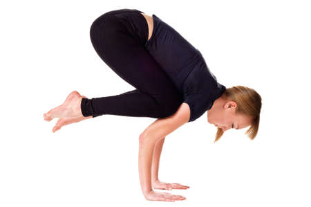 Young woman doing yoga exercise. Isolated over whiteの写真素材