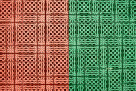 Orange and green mix rubber coatings designed from non-slip squares. It was made for outdoor exercises in stadiums, playgrounds, sport placesの写真素材