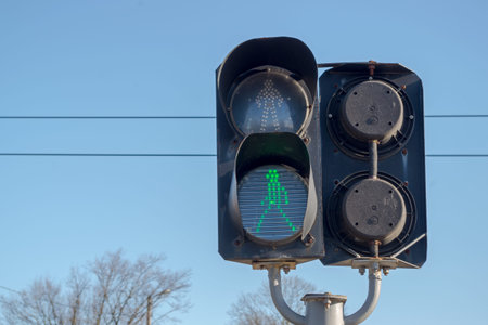 Black two-section traffic light that looks both ways, installed at crossing of railway tracks in...