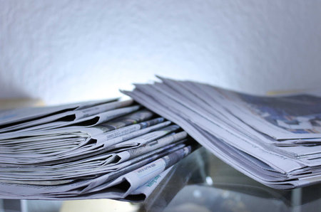 Stack of Newspapers on Table with Backlight