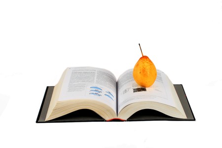 open book and yellow pear isolated over whiteの写真素材