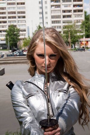 young female with samurai sword outdoorの写真素材