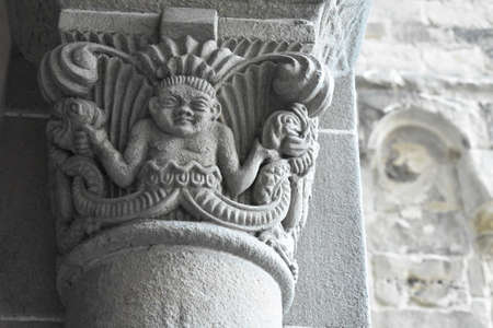 Stone statue of babies heads on a building in Zurichのeditorial素材