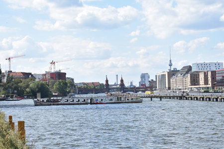 Bridge and boat along the Spree river in Friedrichshain Berlin