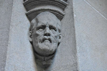 Stone statue of mans head on a building in Zurichのeditorial素材